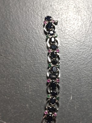 Lot 82 - A contemporary 925 silver sapphire bracelet with emerald and ruby accents.