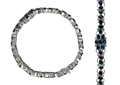 Lot 7 - A contemporary 925 silver sapphire bracelet with emerald and ruby accents.