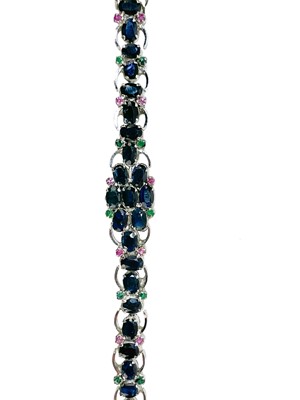 Lot 7 - A contemporary 925 silver sapphire bracelet with emerald and ruby accents.