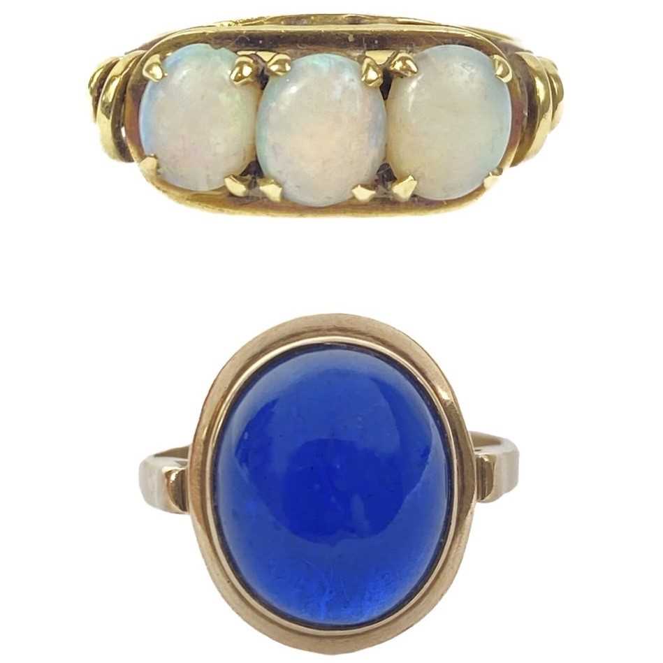 Lot 43 - A 14ct white opal set three stone ring, and a cabochon blue spinel 14ct ring.