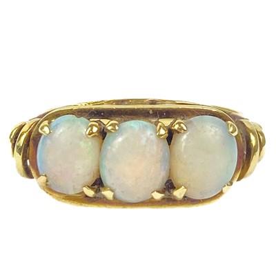 Lot 43 - A 14ct white opal set three stone ring, and a cabochon blue spinel 14ct ring.