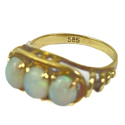 Lot 43 - A 14ct white opal set three stone ring, and a cabochon blue spinel 14ct ring.