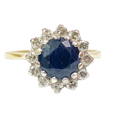 Lot 352 - An 18ct diamond and sapphire set cluster ring.