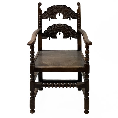 Lot 1235 - An oak elbow chair.