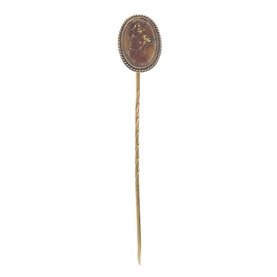 Lot 209 - A 9ct stick pin, the oval head with gold bearing ore.