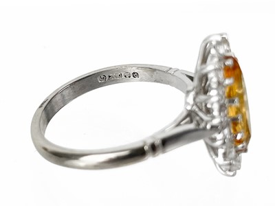 Lot 55 - An 18ct white gold Imperial Topaz and diamond set cluster ring.