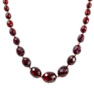 Lot 402 - A cherry amber bakelite faceted bead necklace.