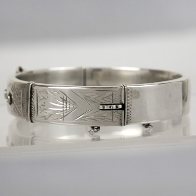Lot 395 - A silver bangle and cross pendant necklace.