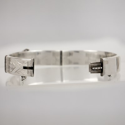 Lot 395 - A silver bangle and cross pendant necklace.