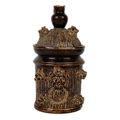 Lot 309 - A brown treacle glaze jar and cover.