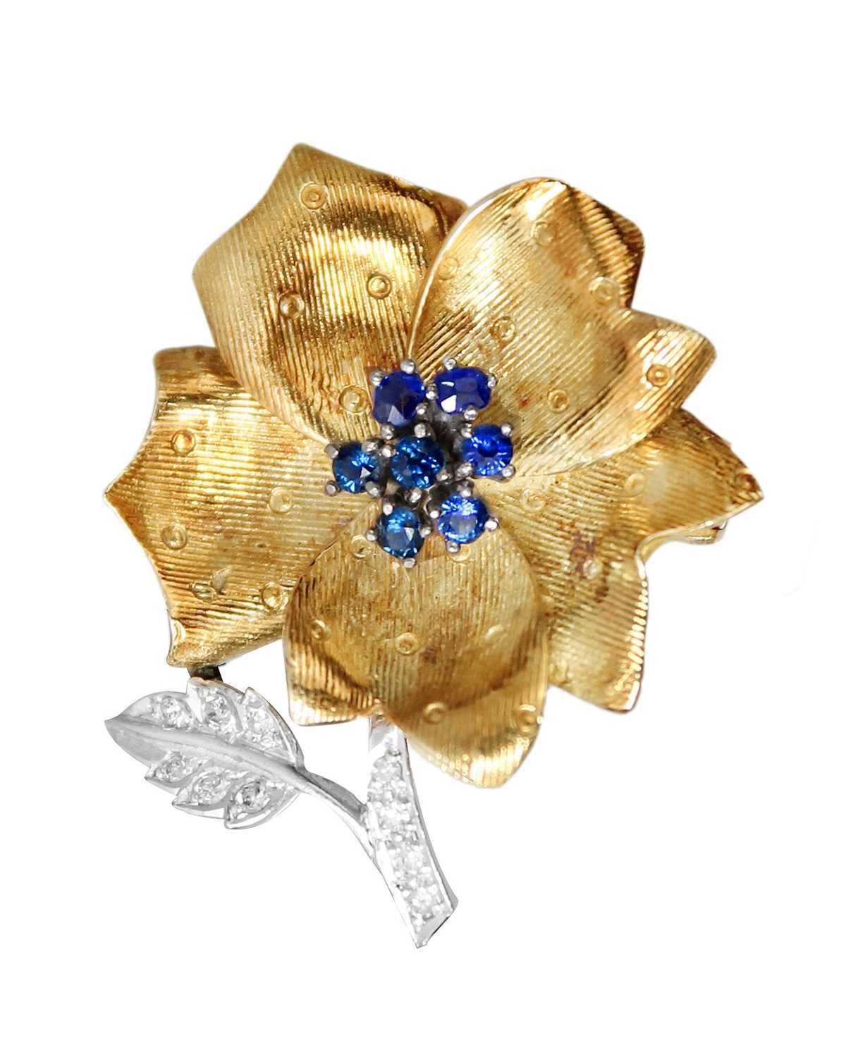Lot 142 - A Ben Rosenfeld for Asprey 18ct white and yellow gold diamond and sapphire set flower brooch.