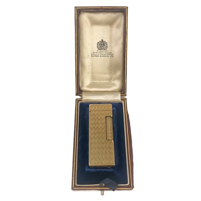 Lot 464 - An Alfred Dunhill 9ct gold engine turned lighter with fitted original box.