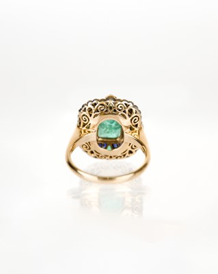 Lot 52 - An attractive 18ct diamond, emerald and sapphire set dress ring.