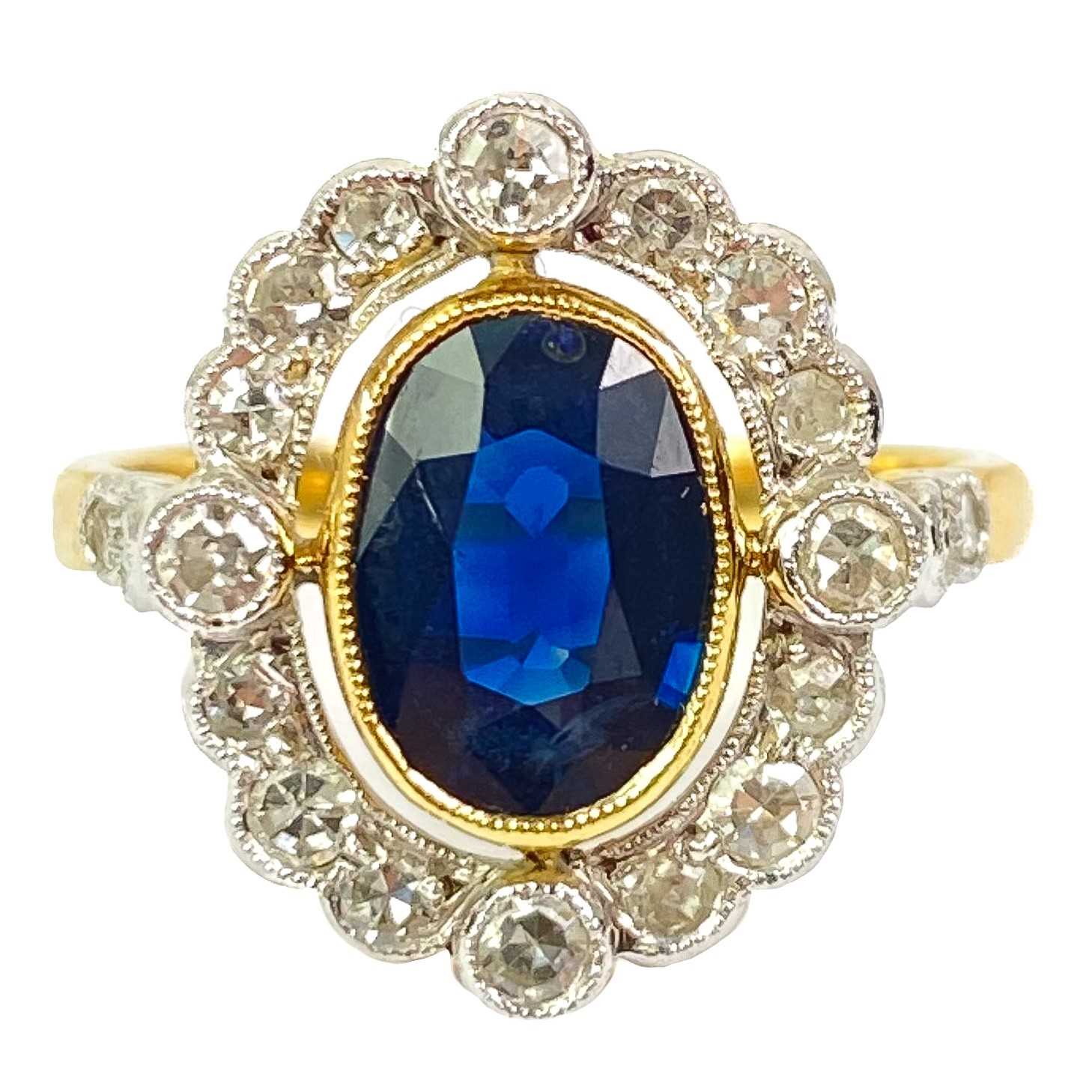 Lot 345 - An 18ct diamond and blue sapphire set halo ring.