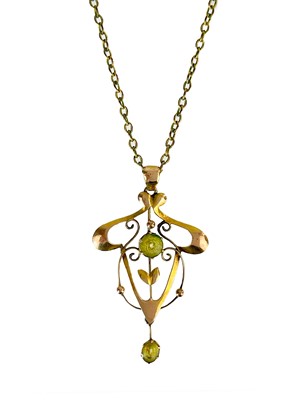 Lot 355 - A 9ct Art Nouveau pendant set with green paste stones.