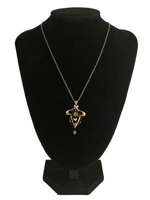 Lot 355 - A 9ct Art Nouveau pendant set with green paste stones.