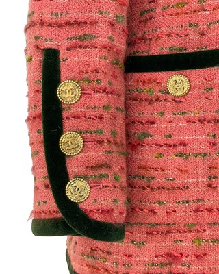 Lot 528 - A Chanel pink boucle tweed and green velvet trim jacket, circa 1990.