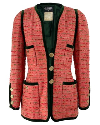 Lot 528 - A Chanel pink boucle tweed and green velvet trim jacket, circa 1990.