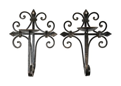 Lot 272 - A pair of wrought iron Arts & Crafts style wall-mounted candle holders.