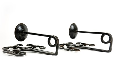 Lot 272 - A pair of wrought iron Arts & Crafts style wall-mounted candle holders.