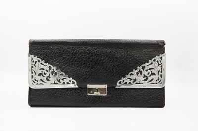 Lot 105 - An Edwardian silver and leather glove wallet. by P W S.