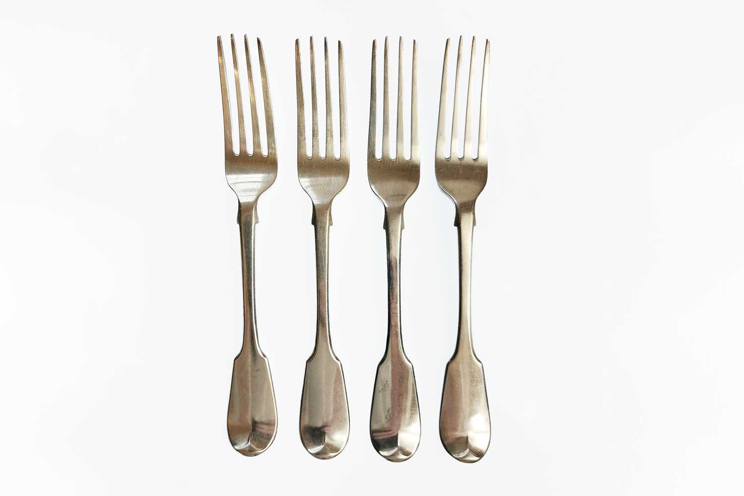 Lot 46 - A George IV silver set of four fiddle pattern table forks by William Chawner.