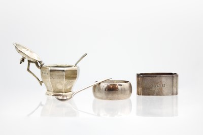 Lot 49 - A George VI silver hinge lidded mustard pot, associated spoon, and two silver napkin rings.