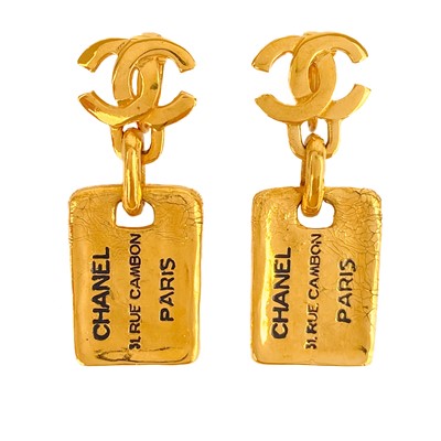 Lot 470 - A Chanel 24ct gold-plated pair of CC and label pendant earrings, circa 1980's.