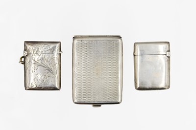 Lot 163 - A George V silver engine turned match case and two silver vesta cases.