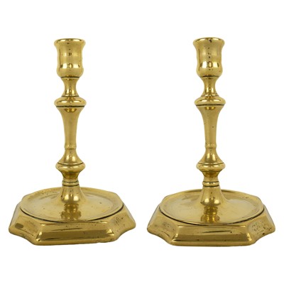 Lot 70 - A pair of Georgian cast brass candlesticks.