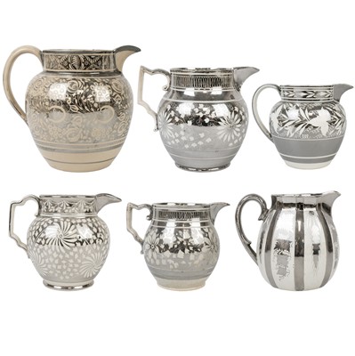 Lot 352 - A group of six silver lustre jugs.