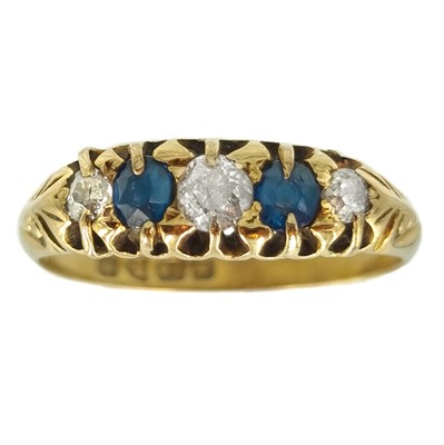 Lot 33 - An Edwardian 18ct diamond and sapphire set five stone ring.