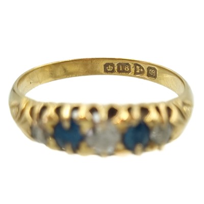 Lot 33 - An Edwardian 18ct diamond and sapphire set five stone ring.