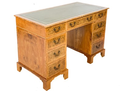 Lot 105 - A 20th century figured yew pedestal desk by Abbey Reproductions, Penzance.
