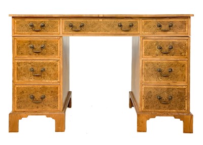 Lot 105 - A 20th century figured yew pedestal desk by Abbey Reproductions, Penzance.