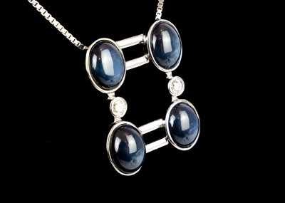 Lot 267 - An 18ct white gold contemporary star sapphire and diamond set pendant necklace.