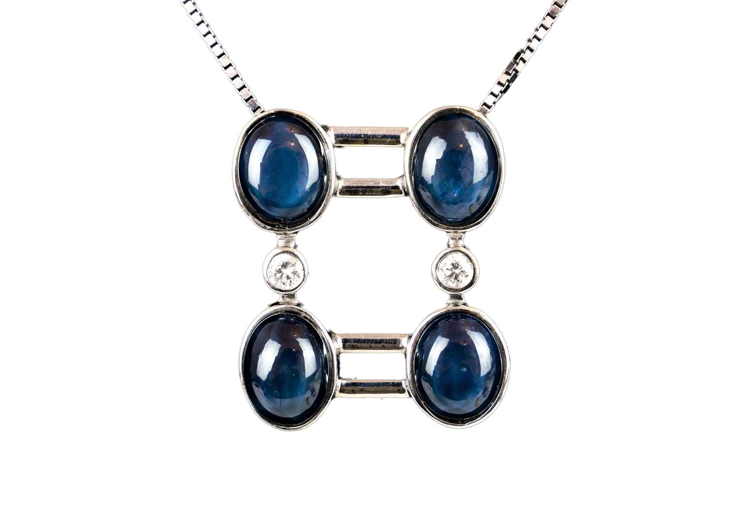 Lot 267 - An 18ct white gold contemporary star sapphire and diamond set pendant necklace.