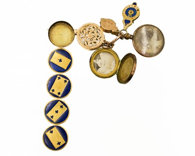 Lot 8 - A selection of four gold charms and a rolled gold frame glazed panel locket.