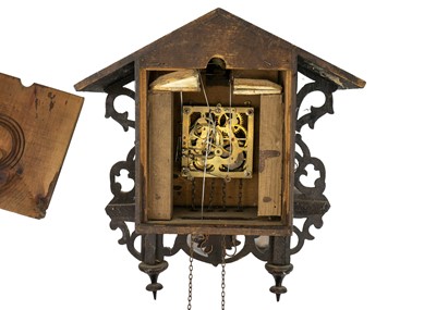 Lot 369 - A Black Forest oak and inlaid cuckoo clock.