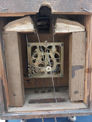 Lot 369 - A Black Forest oak and inlaid cuckoo clock.