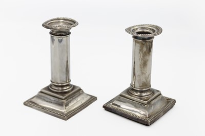 Lot 72 - A pair of George V silver candlesticks by William Neale.