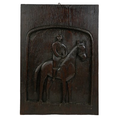 Lot 145 - A naive oak plaque carved with a mounted horse.