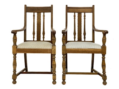 Lot 86 - A pair of Arts and Crafts oak armchairs.