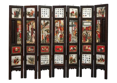 Lot 24 - A Chinese alabaster and hardwood seven paneled screen, Qing Dynasty, late 19th century.