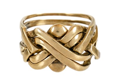 Lot 102 - A 9ct gold six-band puzzle ring.