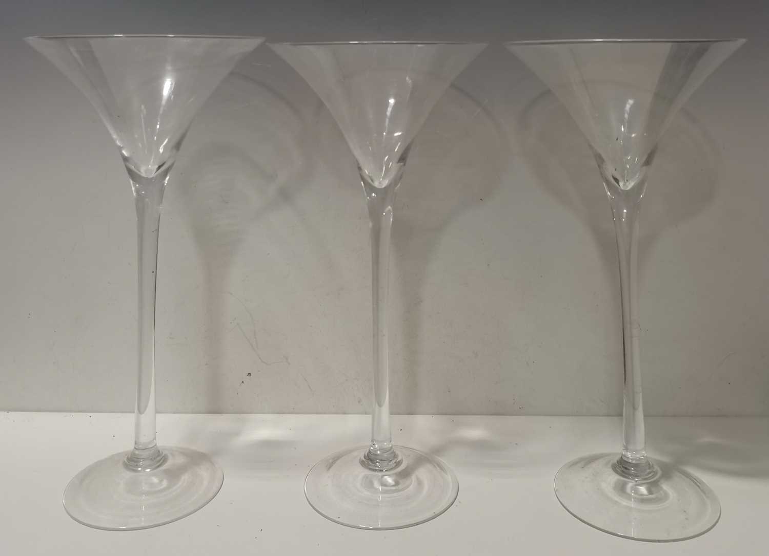 Lot 188 Nine glass martini vases, 41cm tall with a