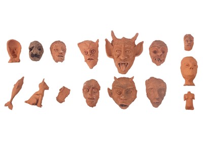 Lot 323 - A collection of fired terracotta masks by Bob Jay (1963).