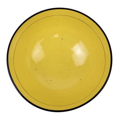 Lot 192 - A 19th century canary yellow English pottery bowl.