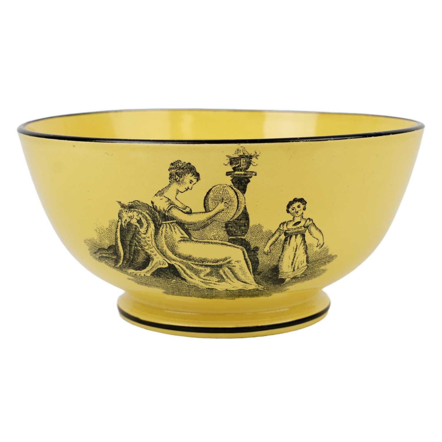 Lot 192 - A 19th century canary yellow English pottery bowl.