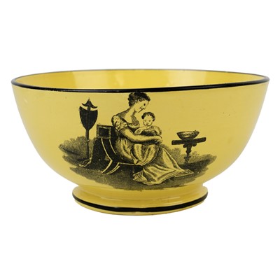 Lot 192 - A 19th century canary yellow English pottery bowl.